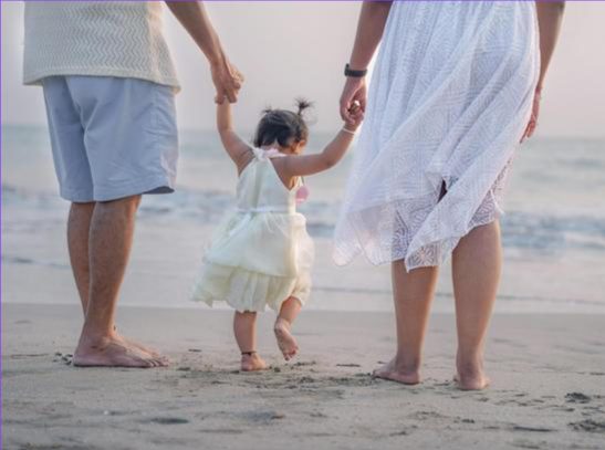 kid and family on the beach