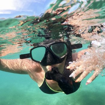 Woman snorkeling in transparent Caribbean waters during Saona Island speedboat tour