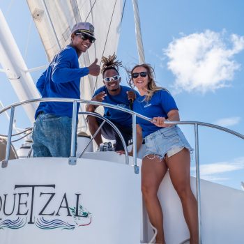 Professional crew helping guests aboard the Quetzal catamaran