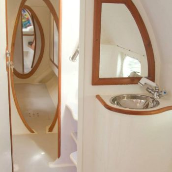 Clean and modern private bathroom inside the catamaran with sink and mirror