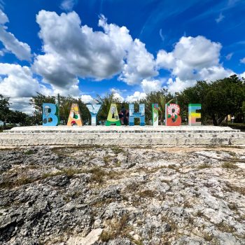 Colorful Bayahibe sign under a blue sky, marking the departure point for Quetzal Excursions’ Saona Economical tour in the Dominican Republic